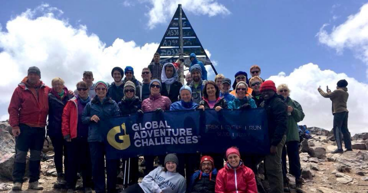 Group of participants stood at the summit of Mount Toubkal